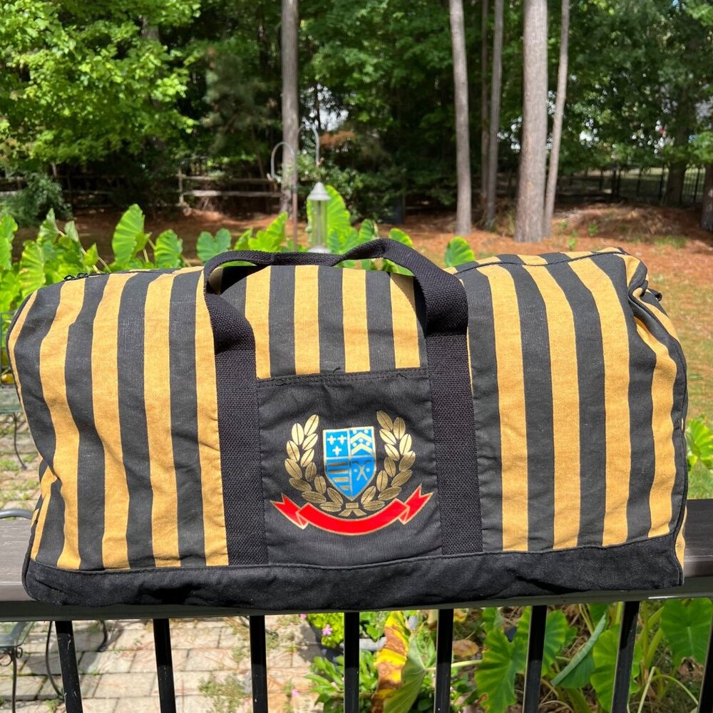 Avon Black and Gold Striped Travel Duffel Bag with Crest